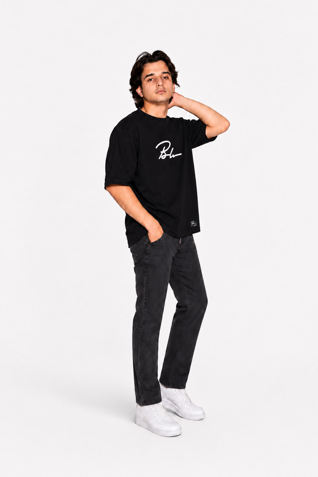 Jet black graphic T-shirt and black jogger pants, relaxed side view