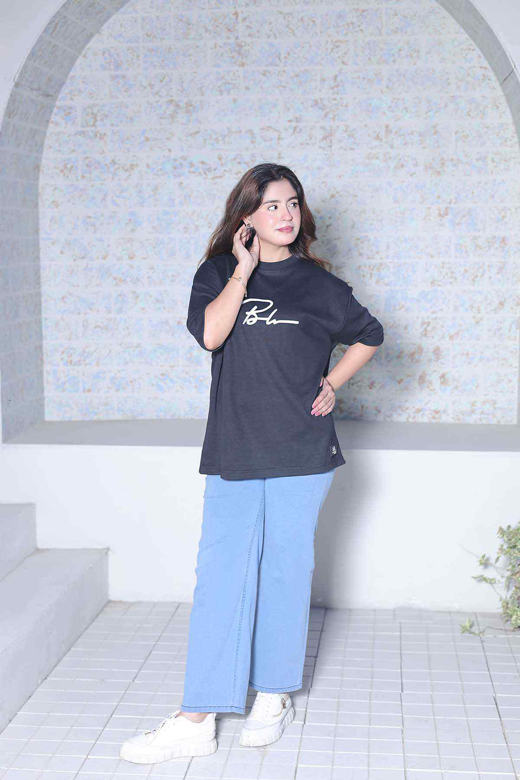 Beleri London black logo T-shirt with light blue wide-leg pants, 3/4 front