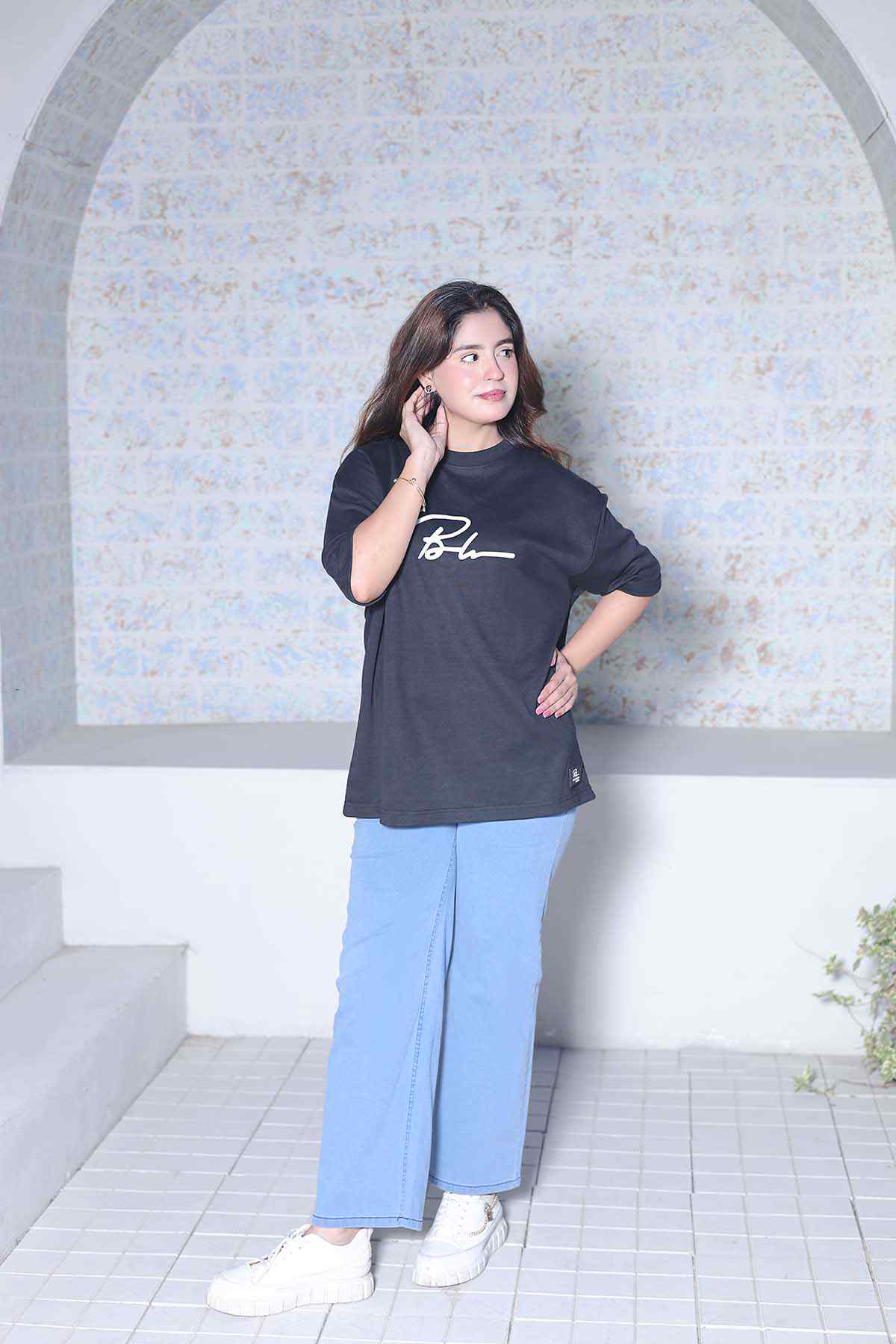 Beleri London black logo T-shirt with light blue wide-leg pants, 3/4 front