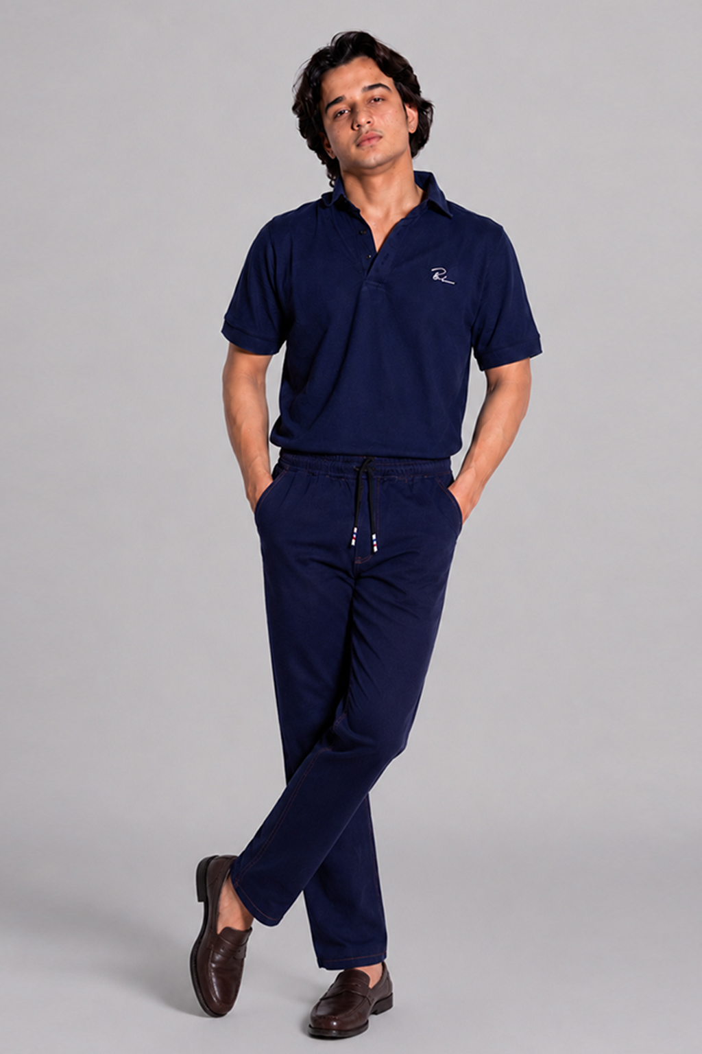 Navy blue polo shirt and drawstring jogger pants, full length
