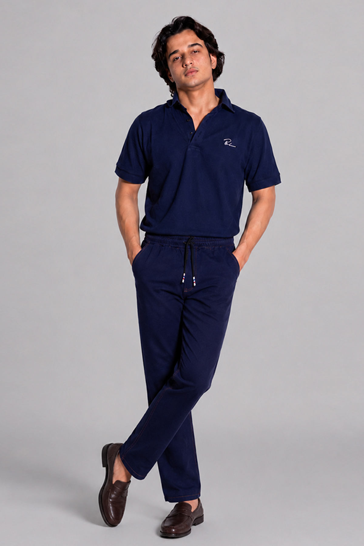 Navy blue polo shirt and drawstring jogger pants, full length