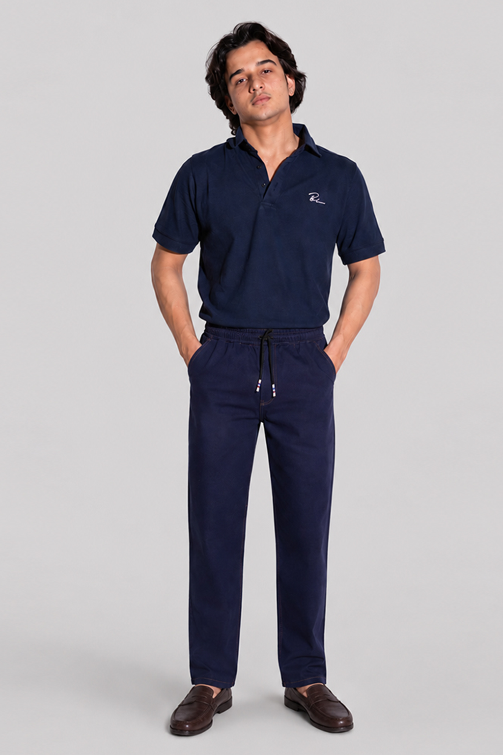 Navy blue polo shirt with logo and drawstring jogger pants