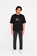 Jet black graphic T-shirt and black jogger pants, white sneakers