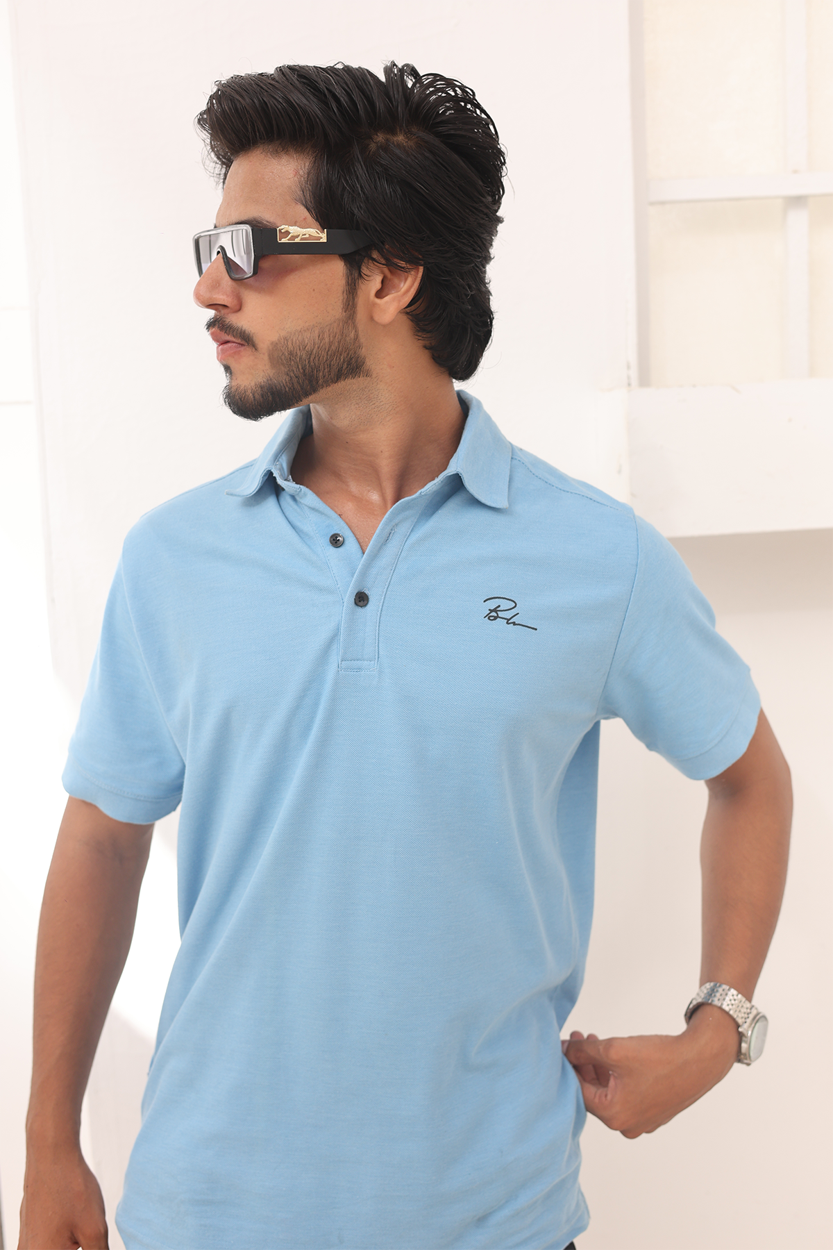 Sky blue polo shirt with embroidered chest logo and buttoned placket