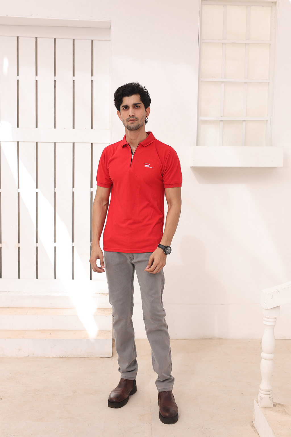 Red polo shirt with short sleeves, button placket, and small chest logo worn by model.