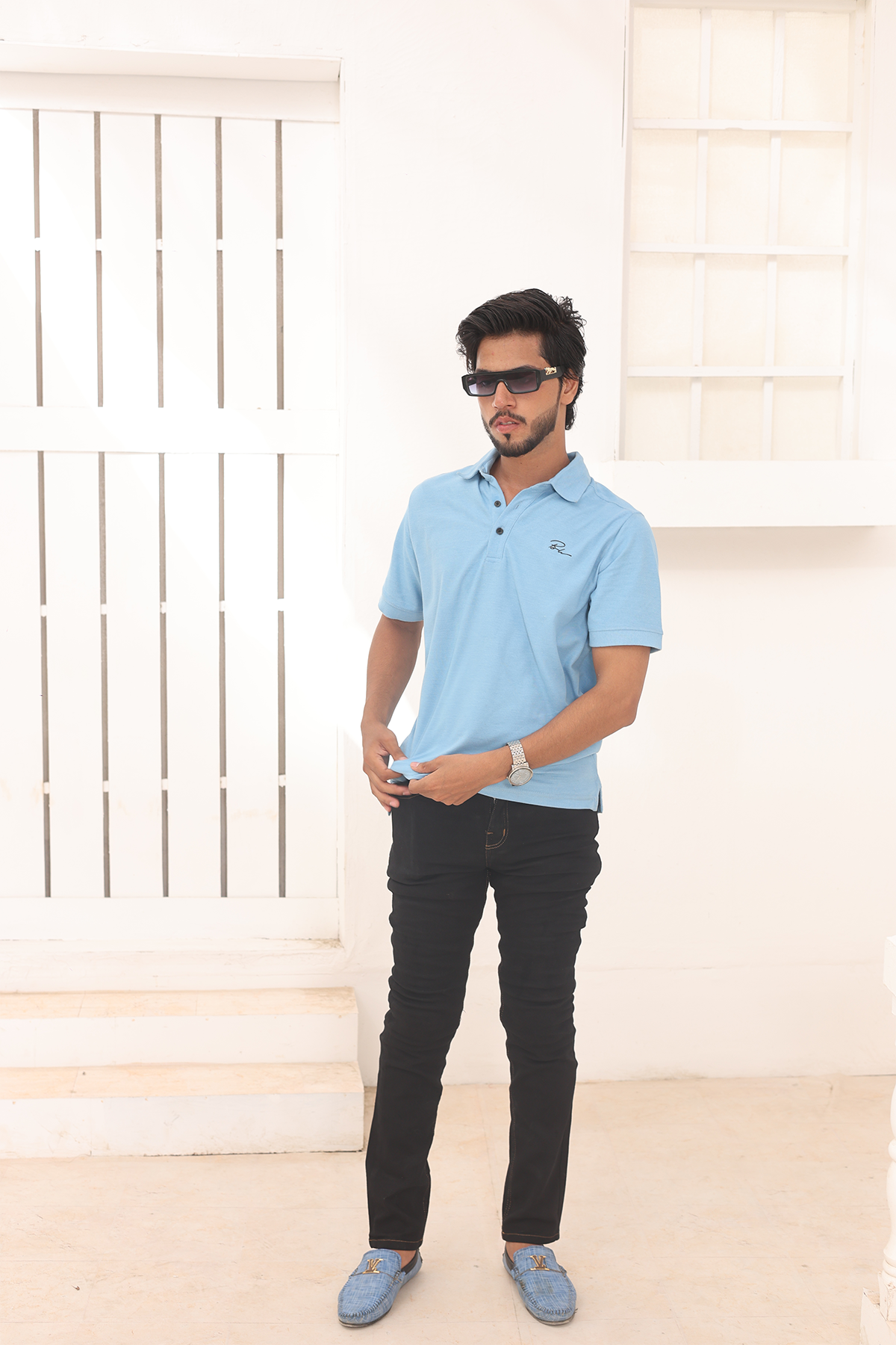 Sky blue polo shirt with buttoned collar and short sleeves